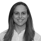A black and white headshot of Marilis Sattolo, smiling and facing the camera